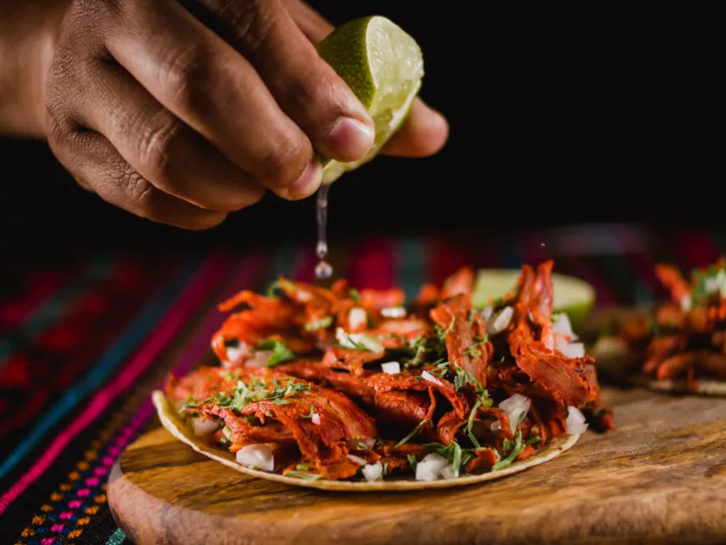 El origen de los tacos al pastor es una historia de migración, fusión cultural y creatividad mexicana. Este platillo se convirtió en uno de los grandes símbolos de la gastronomía mexicana. Descubre cómo nació, por qué se sirve en trompo y cómo conquistó al mundo.